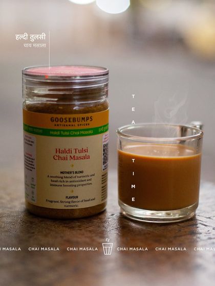 Tea time is made even better with my Haldi Tulsi Chai Masala. A steaming glass of tea sits next to the jar, promising a fragrant and soothing brew with strong notes of basil and haldi.
