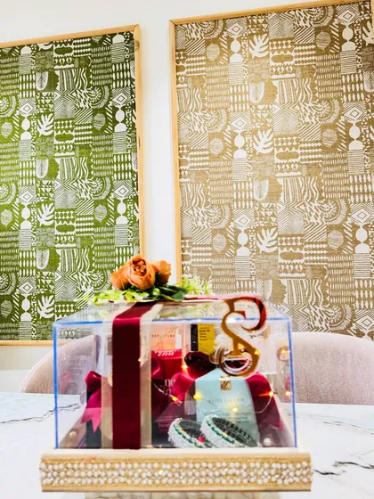 A luxurious acrylic box curated with the finest makeup must-haves from brands like Estée Lauder and Bobbi Brown, wrapped in rich velvet ribbons.