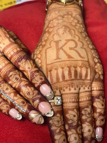 Here’s another stunning option for an engagement. The soft nude base is the perfect canvas for these sculpted gold accents and delicate gem placements, creating a look that is both traditional and modern.