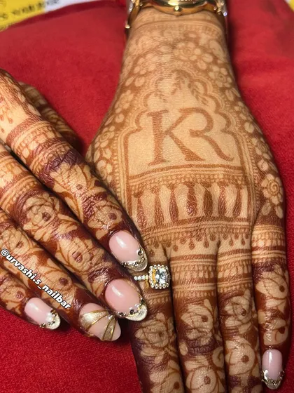 Here’s another stunning option for an engagement. The soft nude base is the perfect canvas for these sculpted gold accents and delicate gem placements, creating a look that is both traditional and modern.