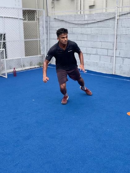 A tennis player executing a lateral sprint after a shuffle. This drill focuses on the transition from controlled shuffling to maximum speed, improving court coverage and recovery time between shots.