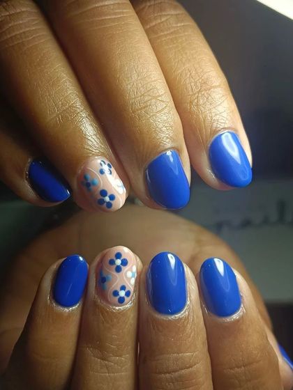 Blue is one of the colors of the season. These gel nails feature intricate floral art on an accent nail, showing my team's finesse.