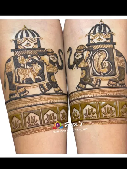 A stunningly detailed elephant design on the arms, part of a royal bridal mehendi.