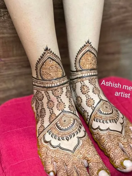 A delicate and beautiful foot design with a central mandala and intricate patterns extending to the ankles.