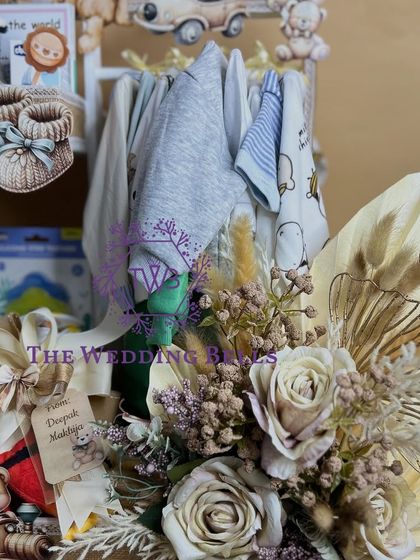 A detailed shot of the floral arrangement and personalized tag on our baby shower hamper. Every element is crafted with love.