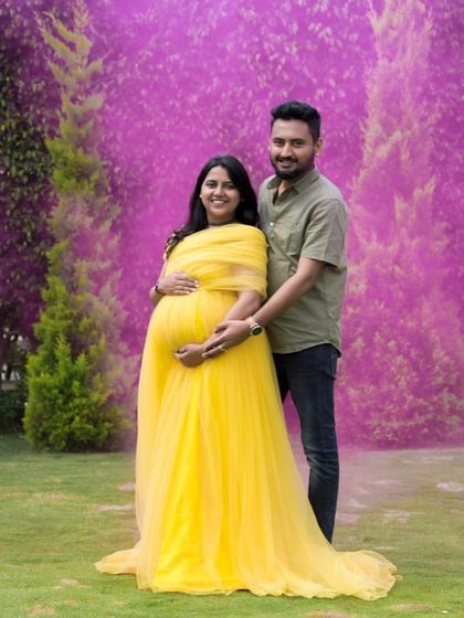 Have fun with your gender reveal or maternity shoot using props like color smoke. This bright yellow gown provides a beautiful contrast, making the photos even more vibrant and memorable.