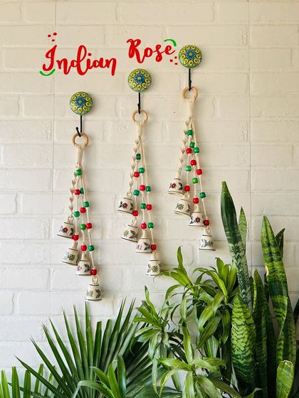 Our 'Symphony Chimes' in the 'Indian Rose' color combination. This bunch of four small ceramic bells with macrame knots and colorful beads is a beautiful addition to any wall, balcony, or garden.