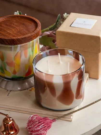 Two of our signature jar candles, one with a reusable Indian Rosewood lid and the other an open three-wick design. Both are made with natural soy wax to ensure a clean burn that fills your space with luxurious fragrance.
