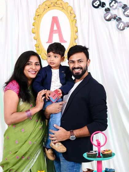 A classic family portrait against the party backdrop. We ensure we get that perfect shot of everyone looking their best.