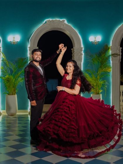 Dancing the night away. This deep red ruffled ball gown has incredible movement, creating a beautiful, full circle as the couple dances during their evening photoshoot.