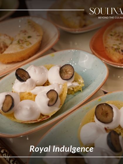 Royal indulgence on a plate. This dish features a creative take on a classic, topped with fresh blueberries and delicate meringue.