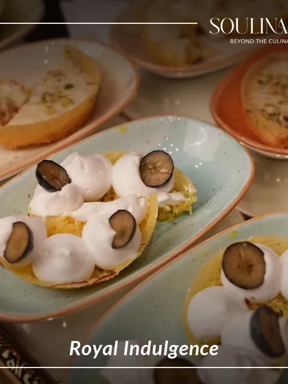 Royal indulgence on a plate. This dish features a creative take on a classic, topped with fresh blueberries and delicate meringue.