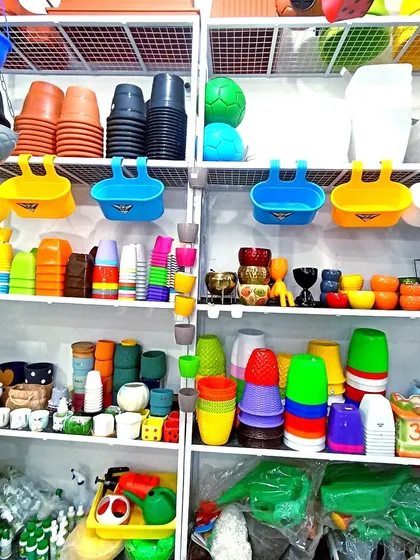 My shop shelves are stocked with a wide variety of colorful plastic and ceramic pots and planters, including railing and hanging pots.