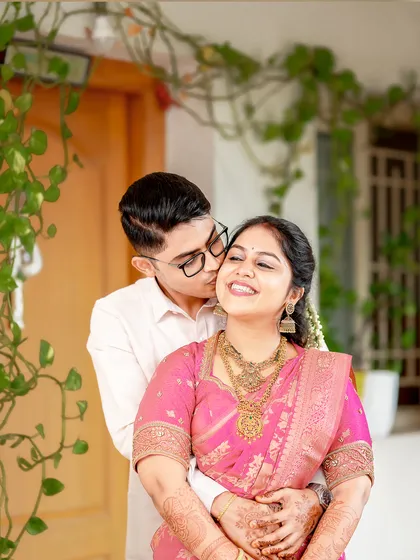 It's the in-between glances and gentle gestures that tell the real story. This candid shot of a groom's affectionate kiss during their Coimbatore wedding captures the pure, unscripted love between the couple.