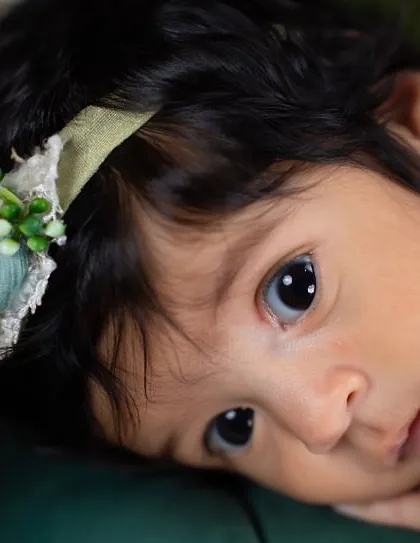 Those wide, curious eyes are just captivating. This is a beautiful example of an "awake" shot during a newborn session, capturing a moment of quiet observation.