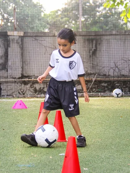 A close-up of footwork during a cone drill. Mastering these foundational movements is crucial for developing the confidence to take on opponents in a match.