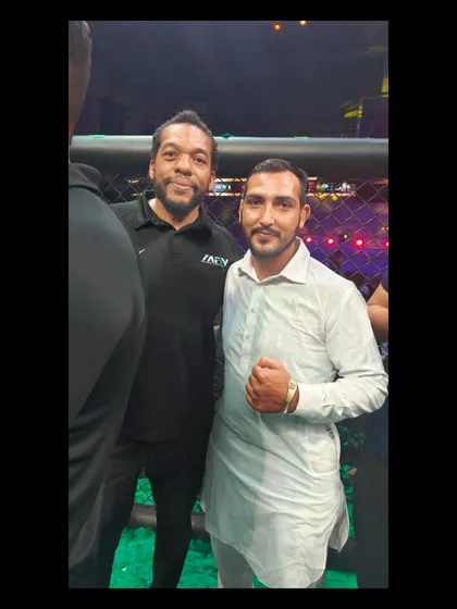 A guest at an MFN event posing with one of the international referees.