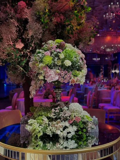 An unapologetic flush of sparkle and glitter. This close-up of a floral centerpiece on a mirrored table reflects the dazzling ballroom, filled with light and luxury to celebrate two special souls.