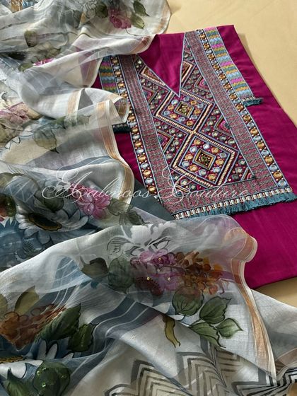 This deep berry handloom cotton kurta features a yoke intricately adorned with thread, dabka, and mirrorwork. It is paired with a hand-painted floral dupatta on premium silk chanderi.