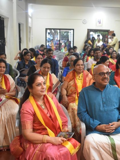 A candid photo of the audience, including students and parents, enjoying the performances at our Kannada Rajyotsava celebration.