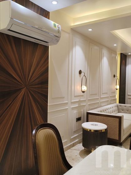 A detail shot showing the sunburst teak veneer panel next to the classic wainscoting. This juxtaposition of modern woodwork and traditional moulding creates a unique and layered look.