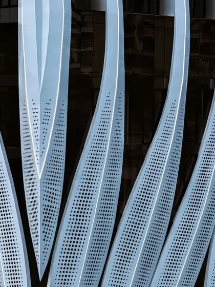 A close-up of the perforated metal panels, demonstrating the level of detail and craftsmanship involved in the facade's construction.