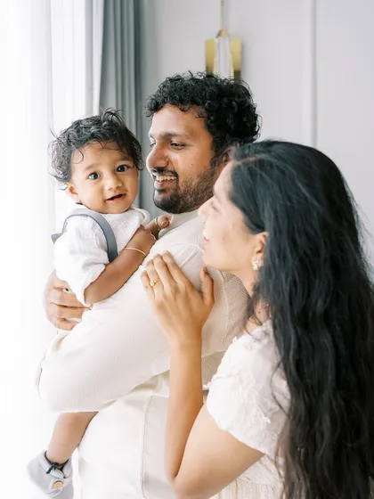 A family portrait with beautiful backlighting from a window, creating a soft and dreamy feel.