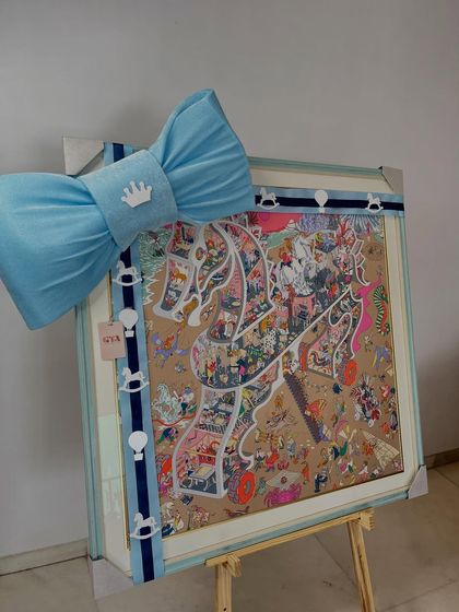 A beautifully framed piece of art, part of a larger gift set for a baby boy.