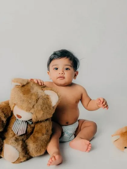 Best friends forever. A simple, classic portrait with a teddy bear is a timeless way to capture your baby's sweetness.