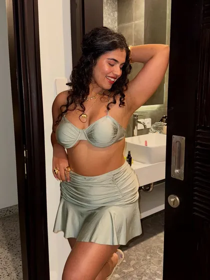 A happy, smiling shot before heading out. Feeling good in your outfit is the first step to having a great time.
