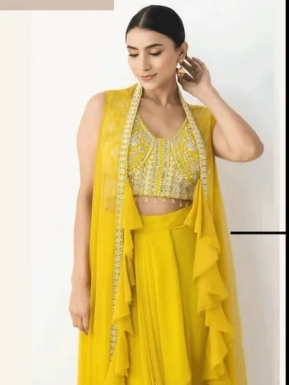 A close-up of the stunning hand-embroidered blouse of the yellow Indowestern set. The pearl and bead work is exquisite.