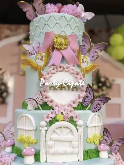 A close-up of the beautiful fairy house cake. I work with the best bakers to ensure the cake is not just delicious but also a stunning part of the overall decor.