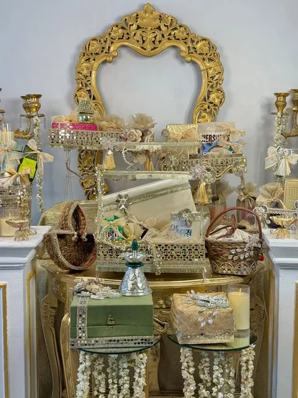 My 'Chandni Raatein' collection is an ode to the magic of festive nights. This display showcases a variety of my luxury Diwali hampers, featuring ornate mirrored baskets, velvet boxes, and antique-style stands, all filled with thoughtful treats.