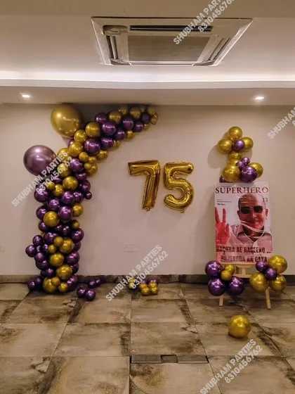 A special 75th birthday celebration with a purple and gold balloon arrangement and a personalized "Superhero" poster.