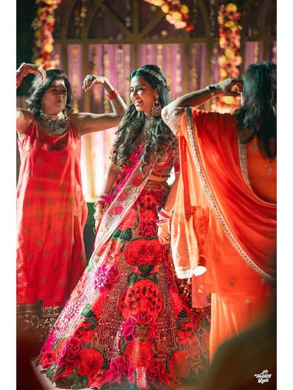 The bride dancing with her friends and family, a moment filled with color, light, and happiness.