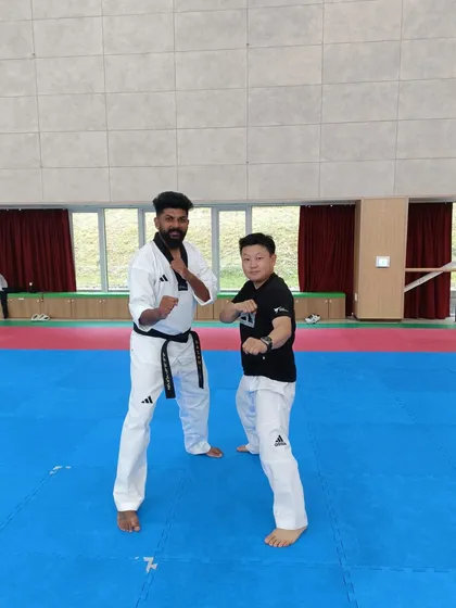 Sharing a fighting stance with another international participant. Taekwondo is a universal language.