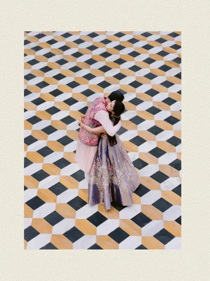 A kiss on a stunningly patterned floor, seen from above. A unique and artistic perspective on a classic romantic moment from their Udaipur wedding.