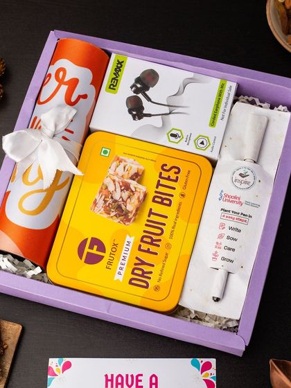 A thoughtful mix of utility and treats, this hamper includes a plantable pen, a box of dry fruit bites, earphones, and a branded bottle. It's a great way to show appreciation to employees or clients.