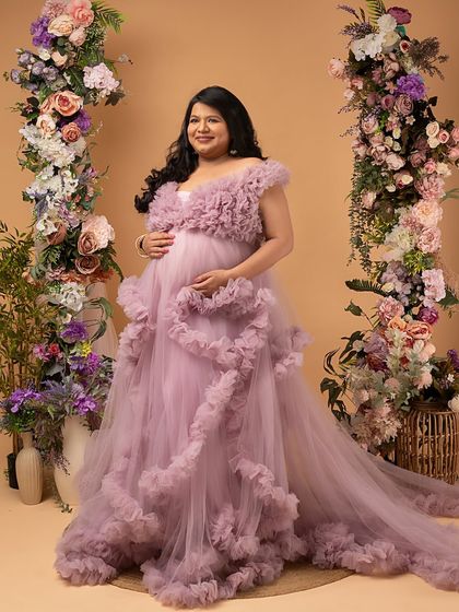 A portrait of a warrior. This mother of twins is wearing a stunning ruffled gown, a symbol of the beautiful victory after a challenging journey. Her strength is palpable.