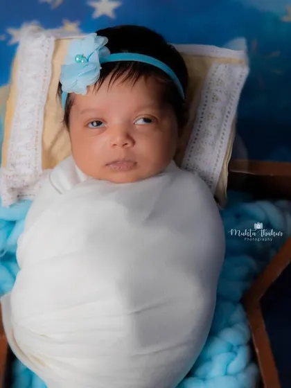 Wide-eyed and wonderful. This newborn girl is taking in all the magic of her starry night photoshoot.