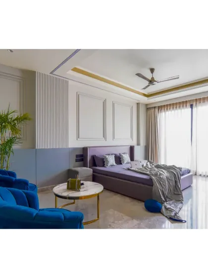 This bedroom in our Gurgaon project features a neo-classical theme with a modern twist. The wall moldings and pops of royal blue are balanced by clean lines and a calm, grey palette for a graceful and quietly luxurious feel.
