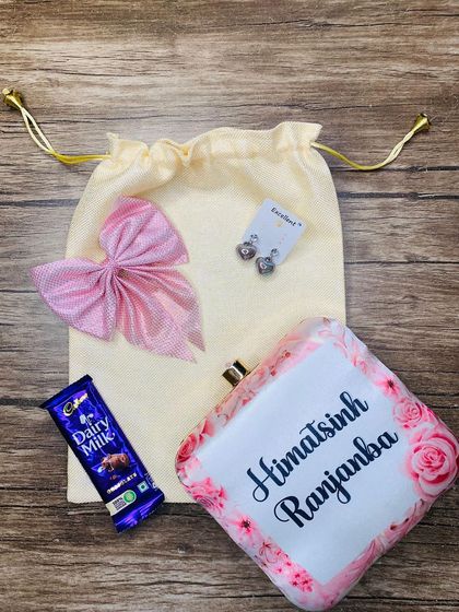 A floral and elegant name-customized clutch combo for your sister.