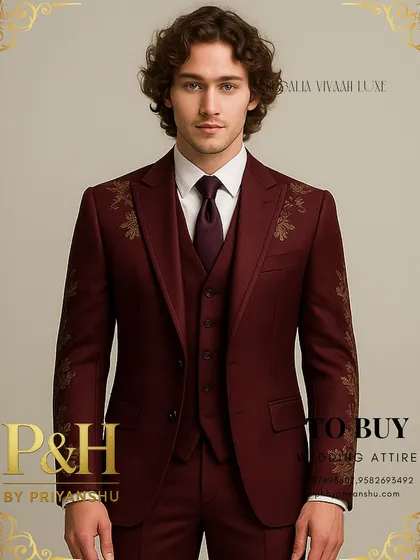 This portrait shot emphasizes the sharp peak lapels and the elegant placement of the golden embroidery on the wine suit.