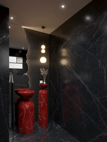 Another view of the red and black marble powder room concept. The irregular-shaped mirror and minimalist pendant lights balance the dramatic stone, adding a touch of modern elegance.