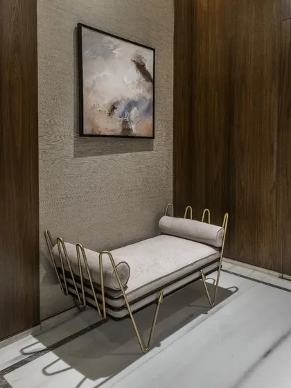 We believe even the simplest of spaces can be spruced up with the right elements. Here, a stunning abstract art piece and a modern, sculptural bench with brass legs transform a simple corner into a point of interest and sophistication.