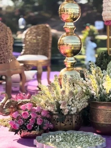 Ornate golden chairs and traditional brass decor pieces for a royal-themed wedding ceremony.