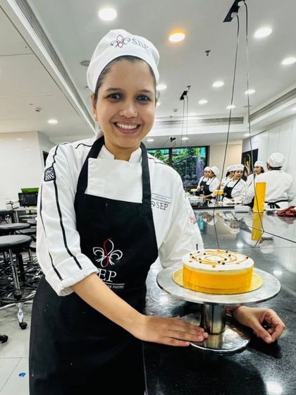 Here I am at pastry school, proudly presenting the New York-style baked cheesecake I made.