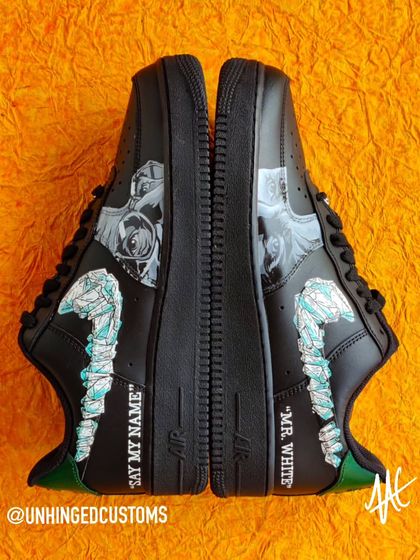 A top-down view of the Breaking Bad AF1s, showing the two portraits and the crystal-meth-inspired swooshes.