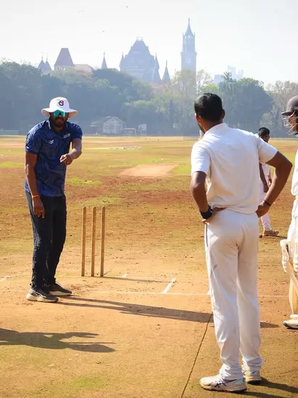 A mid-pitch strategy discussion with the coach during a match simulation. We teach our players to think tactically on the field.