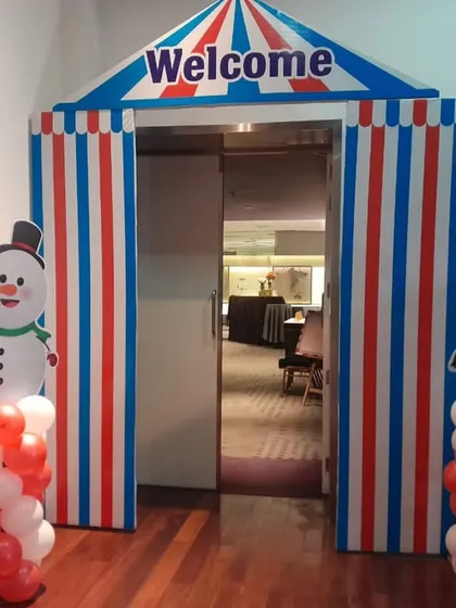 A custom-built carnival tent entranceway, complete with snowman and elephant props. This kind of immersive entrance makes guests feel like they are stepping into another world.